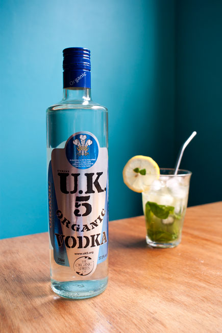Picture featuring a bottle of Utkins UK5 vodka and a glass of lemon basil mojito.
